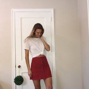 Cranberry suede skirt with buttons.